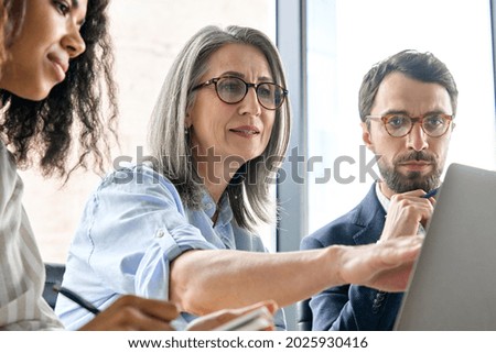 Similar – Image, Stock Photo senior woman working in atelier shop with rolls of fabrics. Cutting fabrics. Small business