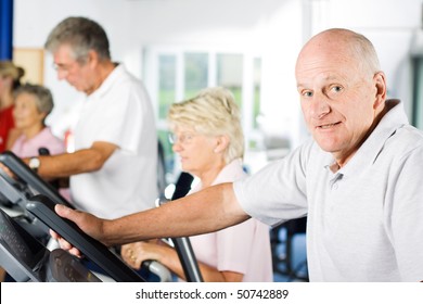 Mature Older Man Exercising In The Gym