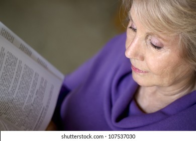 A Mature Older Woman Reading A Book.