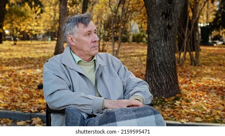 Mature Outdoors Upset Senior Retired Caucasian Man Grandfather With Disability Sit Alone At Wheelchair Depressed Pensive Old Male Person In Older Age Has Health Problems Feel Lonely Think Of Disease