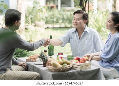 Mature people shaking hands with Asian ethnicity Senior couple New friendship retirement. Group of happy three friends in casual wear Having Meeting Around Table on backyard concept - Powered by Shutterstock