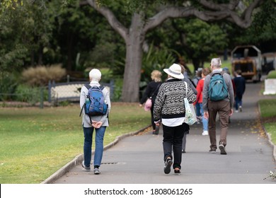 Mature People Walking In A Group In The Park For Sightseeing