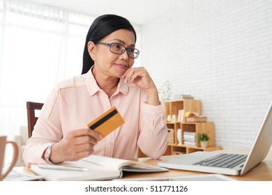 Mature Pretty Woman Paying With Credit Card When Shopping Online