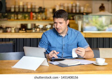 Mature restaurant owner calculating finance and bills of new business  – Entrepreneur online using tablet and calculator to work and calculate financial expenses of small coffee shop business start-up