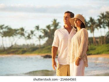 Mature Retired Couple Enjoying Sunset On Beach Vacation