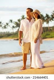 Mature Retired Couple Enjoying Sunset On Beach Vacation