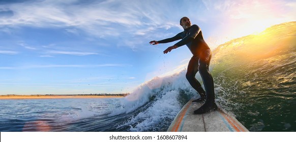 Mature senior adult surfing on a big wave in the ocean - Powered by Shutterstock