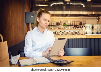 Mature Small Business Owner Calculating Finance Bills Of Activity – Female Entrepreneur Using Digital Tablet To Pay Invoice And Taxes And To Calculate Financial Expenses Of New Business Start-up