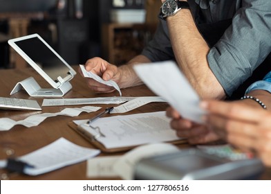 Mature Smalll Business Owners Calculating Finance Bills Of Their Activity. Business People Using Calculator To Work. Closeup Hands Of Man And Woman Calculating Bills And Expenses. 