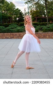 Mature Smiling Woman Dancing Ballet In A Park At Street.