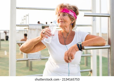 Mature Sportswoman In Workout Station