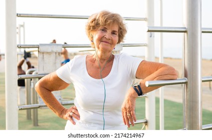 Mature Sportswoman In Workout Station