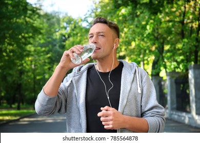 Mature Sporty Man Drinking Cool Water Outdoors