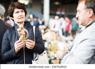 Mature Spouses Buying Retro Handicrafts On Indoor Flea Market