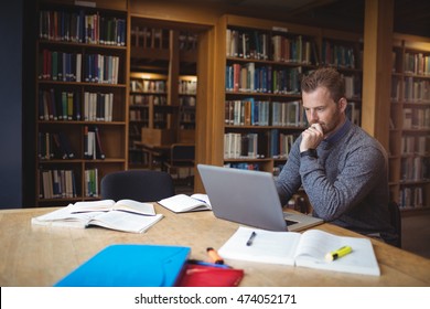 Mature Student Using Laptop At College Library