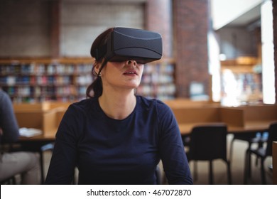 Mature student using virtual reality headset to help with studying in college library - Powered by Shutterstock