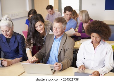 Mature Students In Further Education Class With Teacher