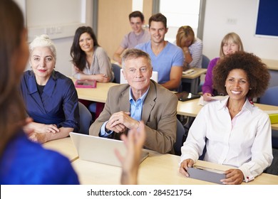 Mature Students In Further Education Class With Teacher