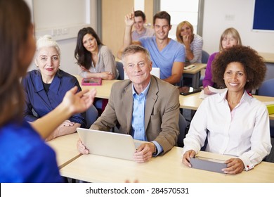 Mature Students In Further Education Class With Teacher