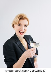 Mature Stylish Elegant Woman In Tuxedo With Glass Of Sparkling Wine. Party, Celebration, Anti Age Concept 