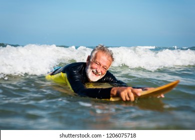 Mature surfer ready to catch a wave - Powered by Shutterstock