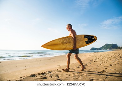 Mature surfer ready to catch a wave - Powered by Shutterstock