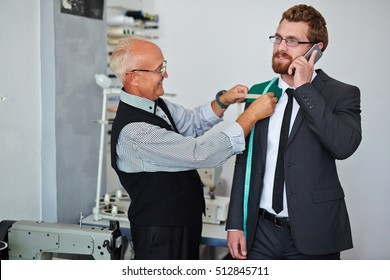 Mature tailor measuring client - Powered by Shutterstock