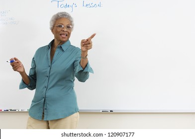 Mature teacher explaining lesson in classroom