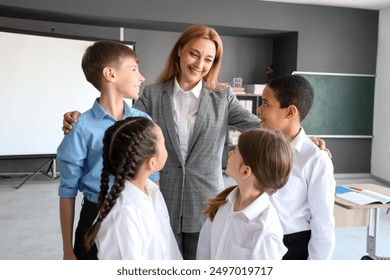 Mature teacher with little pupils in classroom - Powered by Shutterstock