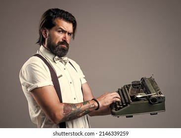 mature typist use vintage typewriter. masculinity and charisma. formal party dress code. old fashioned bearded hipster. journalistic concept. brutal handsome man with moustache. copy space