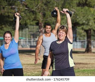 Mature White Female Exercising With Kettle Bell Weights