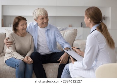 Mature wife and husband talk to therapist during housecall visit at home. Professional medical worker share good optimistic health news to old couple, explain treatment plan. Medicine, insurance cover - Powered by Shutterstock