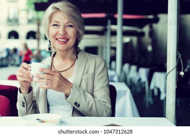 Mature Woman 50s Years Old Is Lunching With Coffee In Cafe.