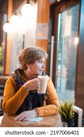 Mature Woman 60s Years Old Is Lunching With Coffee In Cafe.