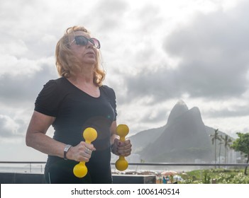 Mature Woman (70-79) Exercising With Dumbells At Public Gym In Ipanema, Rio De Janeiro, Brazil