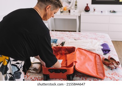 Mature Woman Arriving At The Hotel Room And Unpacking Her Luggage. Summer Trip, Weekend. Concept Leisure And Hobby.