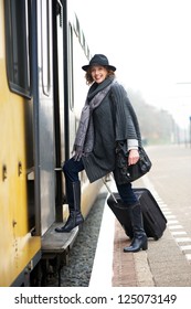 Mature Woman With Bag Walking On To Train