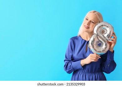 Mature Woman With Balloon In Shape Of Figure 8 On Blue Background. International Women's Day