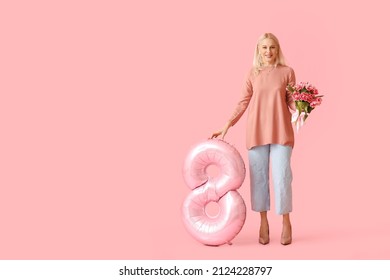 Mature Woman With Big Balloon In Shape Of Figure 8 On Pink Background. International Women's Day