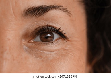 Mature woman with brown eyes, closeup - Powered by Shutterstock