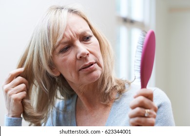 Mature Woman With Brush Corncerned About Hair Loss