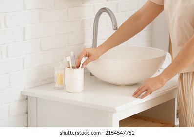 Mature Woman  Brushing Teeth In Bathroom