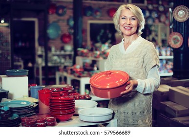 Mature Woman Buying Ceramic Cookware In The Shop