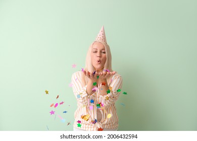 Mature Woman Celebrating Birthday On Color Background