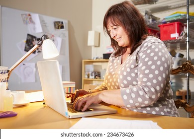 Mature Woman Checking Orders For Home Business On Laptop