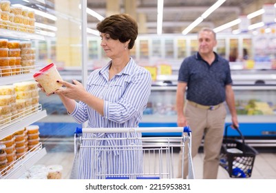 Mature Woman Choosing Sauerkraut Cabbage And Pickles