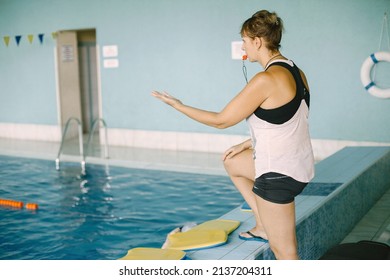 Mature Woman Coach With Whistle By Poolside