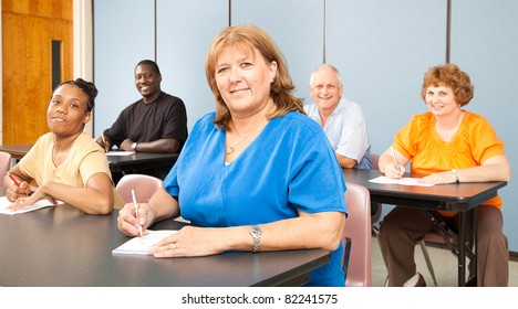 Mature Woman In College, Among A Group Of Other Adult Students.   Banner Orientation.