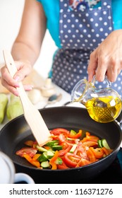 Mature Woman Cooking Dinner On The Kitchen