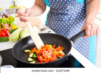 Mature Woman Cooking Dinner On The Kitchen